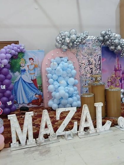 The princess decor during setup, showing the different elements like the shimmer wall and balloon arches coming together.