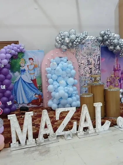 The princess decor during setup, showing the different elements like the shimmer wall and balloon arches coming together.