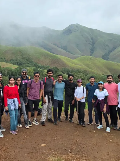 A moment of achievement for our trekking group at Kudremukha. The rolling green hills provide a stunning backdrop for making new friends and unforgettable memories on this classic Karnataka trek.