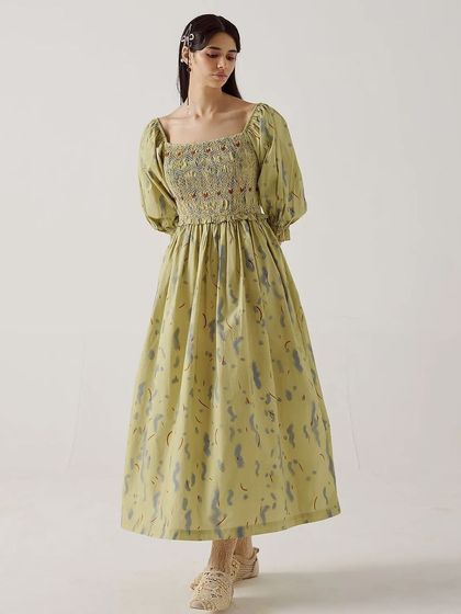 A full-length shot of the Smocked Dress from Cord, showcasing its elegant silhouette against a clean studio background.