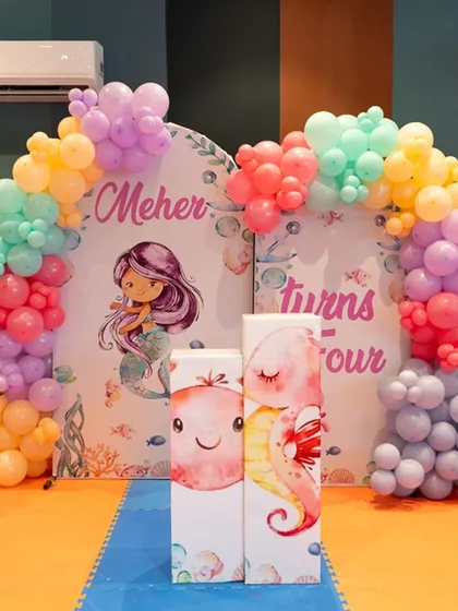 I transform the venue to match your vision. This beautiful mermaid-themed decor, with pastel balloon arches and custom backdrops, created an enchanting underwater world for Meher's fourth birthday.