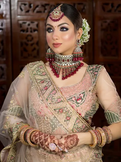 This bride is wearing a beautiful pastel pink lehenga. I used a soft smokey eye and a nude pink lip to create a sophisticated and modern bridal style.