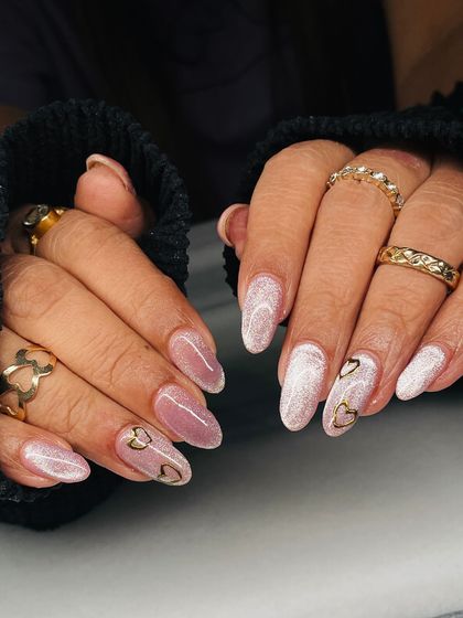 The full two-hand view of the pink shimmer and gold heart nails. It's a beautiful and subtle way to wear your heart on your nails.