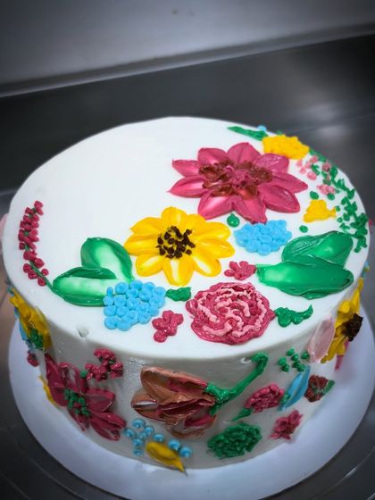 I love what I do, and I want to do it for you. This cake is decorated with colorful, hand-painted buttercream flowers. It's an example of my promise to make honest, beautiful cakes from scratch.
