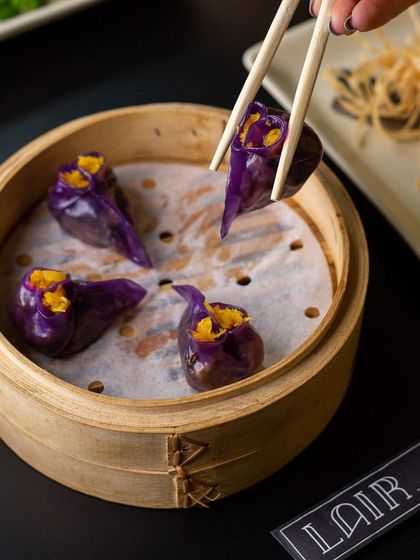 Sear into a succulent, flavourful Asian culinary journey. These purple cabbage and pumpkin dumplings are a unique and delicious offering from our dim sum menu.