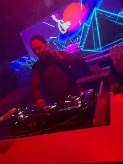 In the zone, with the VJ graphics lighting up the background. I coordinate the sound and visuals for maximum impact.