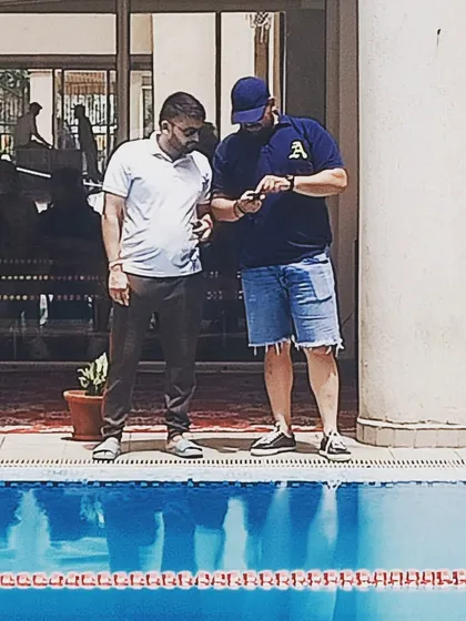 Discussing race strategy and splits by the pool. Every detail matters, and I work closely with my swimmers and their support systems to plan for success.