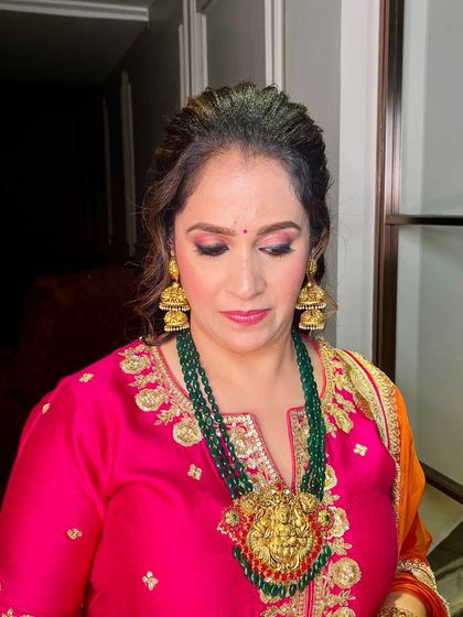 A close-up of this subtle glam look for a guest, featuring soft pink eyeshadow and a matching lip.