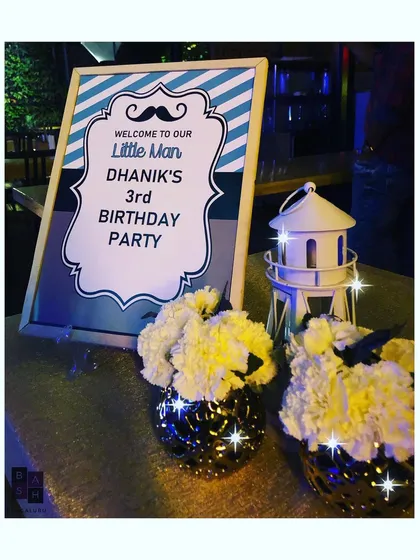We designed this 'Little Man' themed welcome sign for Dhanik's third birthday, setting the tone right from the entrance with its fun mustache graphic and striped pattern.