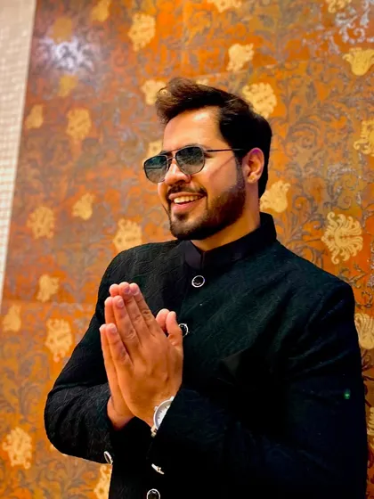 A welcoming 'namaste' in a formal, traditional outfit. A perfect blend of modern style and respect.