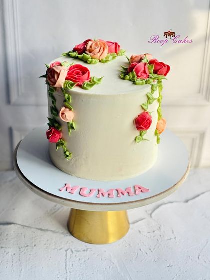 Understated elegance with a floral touch for Mumma. This cake features delicate, hand-piped roses cascading down the side.