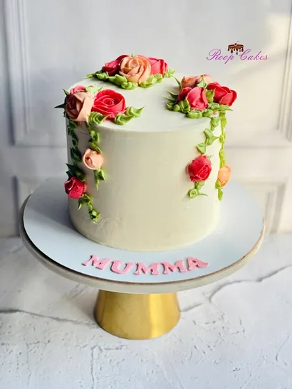 Understated elegance with a floral touch for Mumma. This cake features delicate, hand-piped roses cascading down the side.