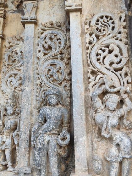 Detailed carvings on a temple pillar, showcasing the rich history and artistry we encounter on our heritage-focused treks.