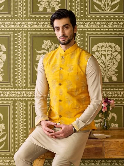 The complete Haldi ensemble, showing the beautiful coordination between the yellow waistcoat and the neutral kurta. It's a timeless choice for any daytime ceremony.