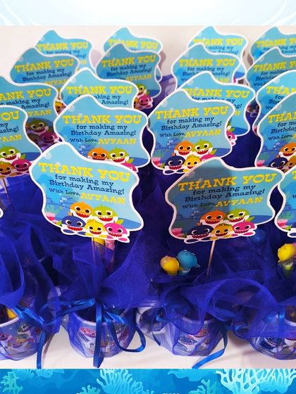 A group of the Baby Shark mug hampers, all ready for Avyaan's birthday party. The personalized tags make each one special.