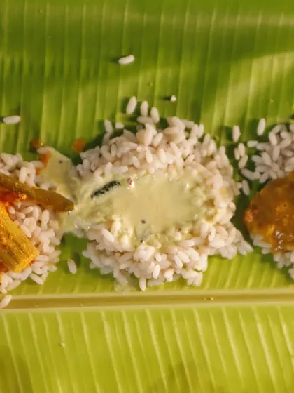 The heart of any Sadya is the interplay of its curries. A classic Sambar, a creamy Pulisseri, and a tangy Raw Mango Curry, each poured over red rice, create a new flavour symphony with every bite.