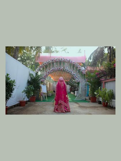The bride's grand entrance, viewed from behind. This shot captures the scale of the venue and the anticipation of the moment as she walks down the aisle.
