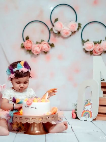 Getting right into the spirit of the cake smash. These photos are all about capturing the pure, uninhibited joy of being a one-year-old.