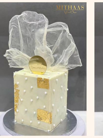 This square, gift-box style cake is a perfect anniversary surprise. It's decorated with a pattern of delicate pearls, patches of 24-carat gold foil, and topped with a beautiful, translucent rice paper bow.