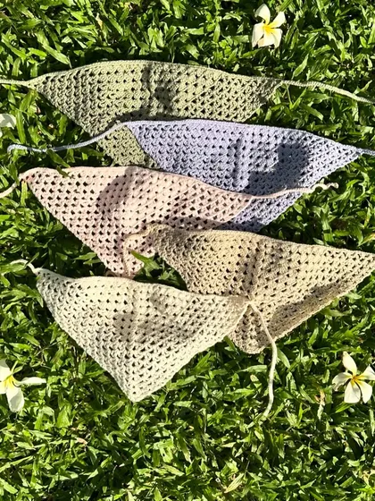 Our crochet bandanas are available in a variety of colors. This flat lay shows some of our favorite pastel and neutral shades, perfect for any season.