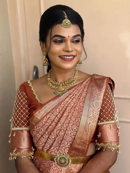 A radiant bride during her pre-wedding rituals. Her hair is styled in a simple side braid, a classic and elegant choice that is perfect for the occasion.