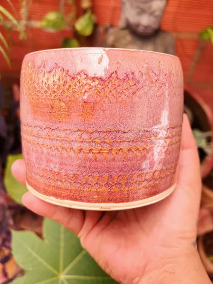 This pink tumbler has a lovely textured pattern from pressing lace into the clay. I am always inspired by the calm and serene statues in my studio.
