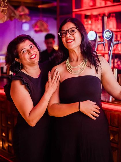 Two friends enjoying a drink and the atmosphere at The Fixx bar.