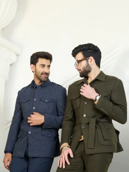 My co-ord sets are designed for the modern gentleman seeking both style and comfort. Here, I present two distinct yet complementary looks: a structured navy Jodhpuri-style jacket and a belted olive green safari jacket, showcasing versatility in contemporary tailoring.