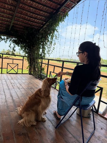 A peaceful moment at our pet-friendly staycation, sharing a treat with Posto while enjoying the view.