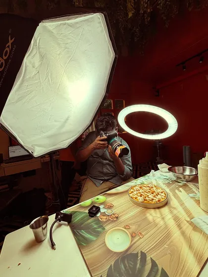 Getting the perfect angle. This behind-the-scenes shot shows me in action, composing the frame for a food product shoot to get the most delicious-looking result.