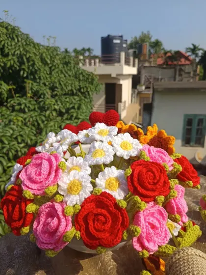 A beautiful bouquet of mixed flowers, with potted flowers arranged at the base.
