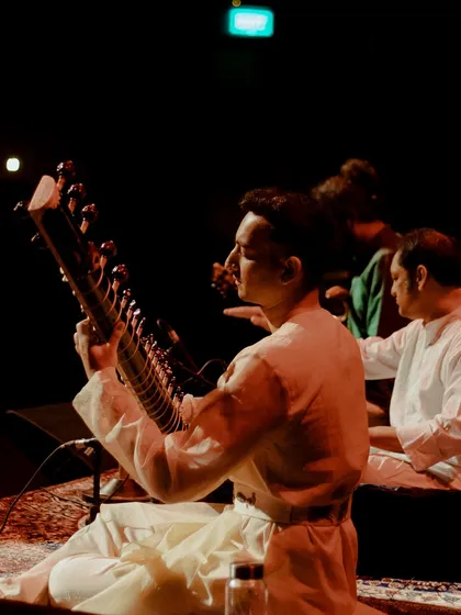 A side view of the candle-lit stage in Chandigarh. You can see my fellow musicians as we prepare to begin a raga, connected by the music and the quiet focus of the room.