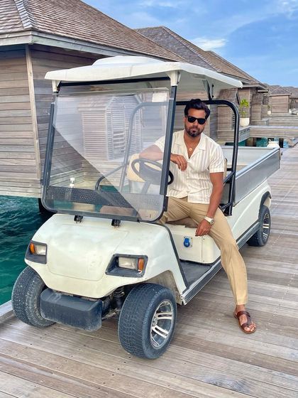 A confident pose in our custom resort wear, showcasing a look that is perfect for a luxury vacation.