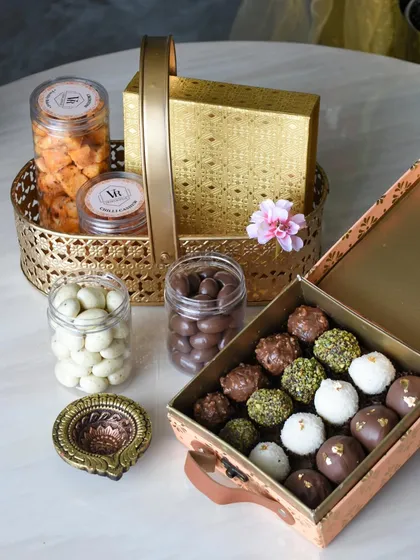 A luxurious Diwali gift set combining a golden basket of treats with a box of my signature assorted truffles. This hamper offers the best of both worlds, with a variety of textures and flavors.