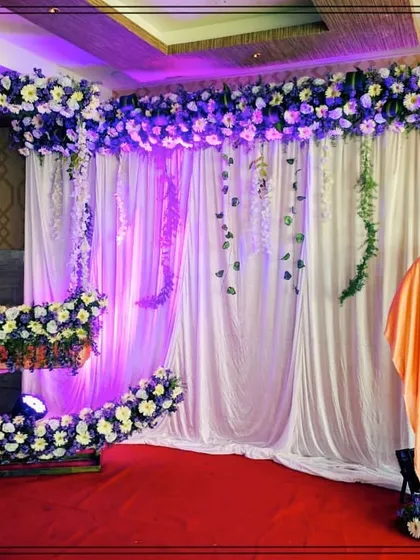 We customize our popular crescent moon cradle design to match your preferred color scheme. This naming ceremony setup features a beautiful combination of purple and white flowers with elegant white drapes.
