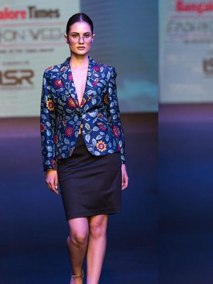 Capturing a modern, structured look on the runway. This image highlights a floral blazer and the model's strong presence, demonstrating my ability to freeze key moments during a fashion show.