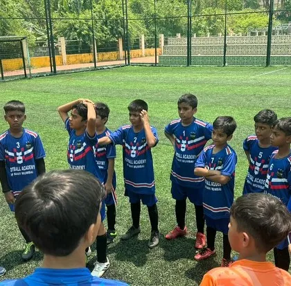 A coach gives a tactical briefing to the Under-12 team during a break at the Goa Football Festival.
