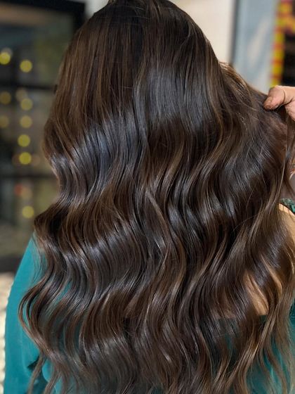 With lights vs. no lights. This rich, wavy brown hair looks incredible in any lighting, showcasing its dimension.