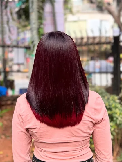 A rich, deep burgundy with a hint of brighter red at the tips. This color looks incredibly luxurious on straight, glossy hair and is one of my favorite looks from this year.