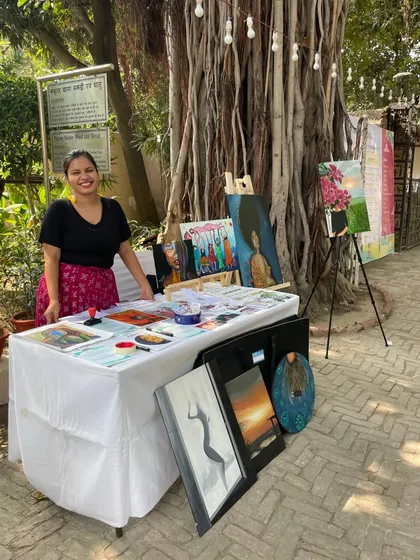 This is me at the Aham Festival, surrounded by my art. It can be nerve-wracking to put your heart on display, but the conversations and connections I make with people who see their own stories in my work make it all worth it.