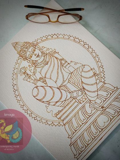 The brown outline of the Devi painting, with my glasses for scale. The serene, reclining pose is captured in these initial lines.