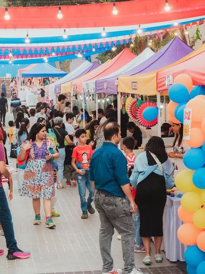 A bustling flea market at the CNS Fiesta. I can organize and set up rows of colorful stalls for vendors, creating a vibrant marketplace atmosphere within your event.