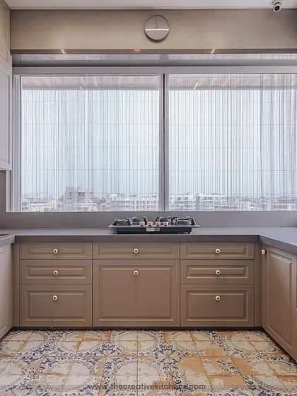 A symmetrical view of this U-shaped kitchen showcases the ample counter space and the harmonious balance between the upper and lower cabinets. The design is both aesthetically pleasing and highly practical for everyday cooking.