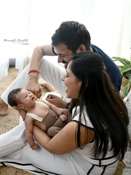 The unposed, real moments are often the best. The genuine laughter and connection as these new parents play with their baby is what family photography is all about. It's a memory you can almost hear.
