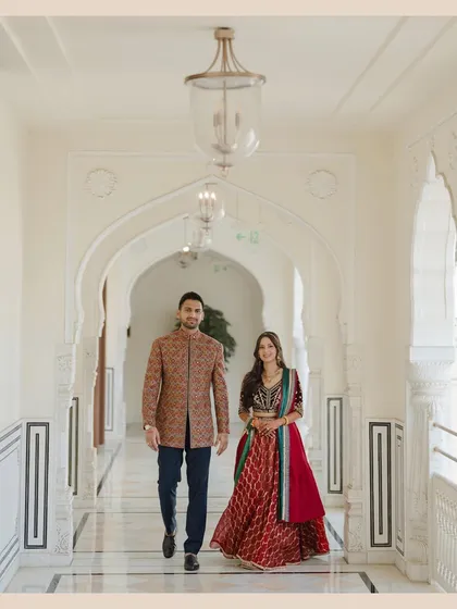 A powerful, confident walk down a palace corridor. This shot showcases the couple as a strong, united pair against a clean, architectural backdrop.