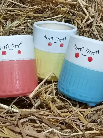 Your plants deserve a stylish home. I offer a variety of quirky and fun ceramic planters, like these cute sleepy-face pots, to match your decor and personality.