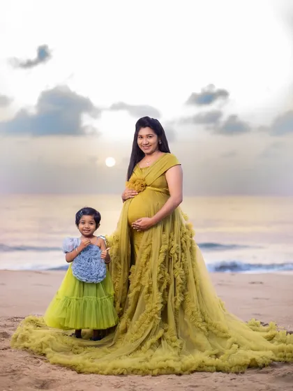 A mother and daughter sharing a golden moment by the sea. This family maternity session captures the beautiful bond that already exists while celebrating the new life on the way.