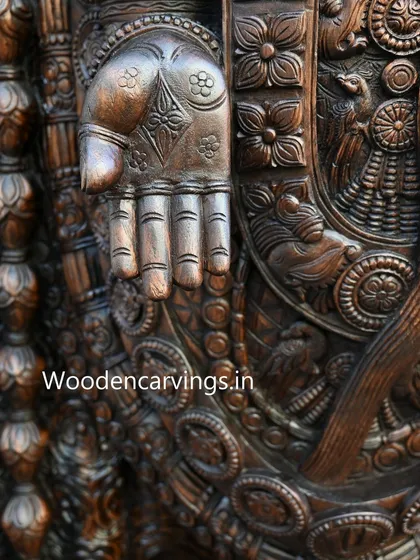 The hand of Lord Venkatajalapathy in the 'Varada Mudra' (gesture of giving boons), intricately carved with floral motifs on the palm. This detail symbolizes the deity's grace and generosity.