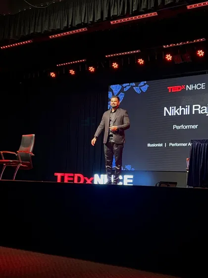 On the iconic red circle, delivering a talk at TEDxNHCE. Being a four-time TEDx speaker has honed my ability to blend complex ideas with illusion, creating keynote presentations that are both engaging and deeply memorable for any corporate audience.