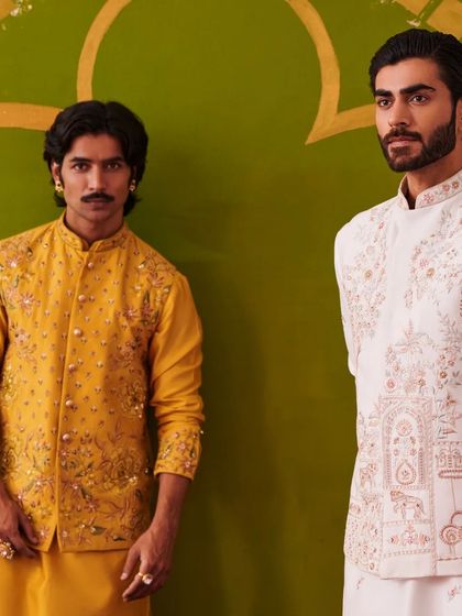 A close-up of the yellow and white kurta sets, highlighting the contrast and the shared elegance of the Nazaakat collection.